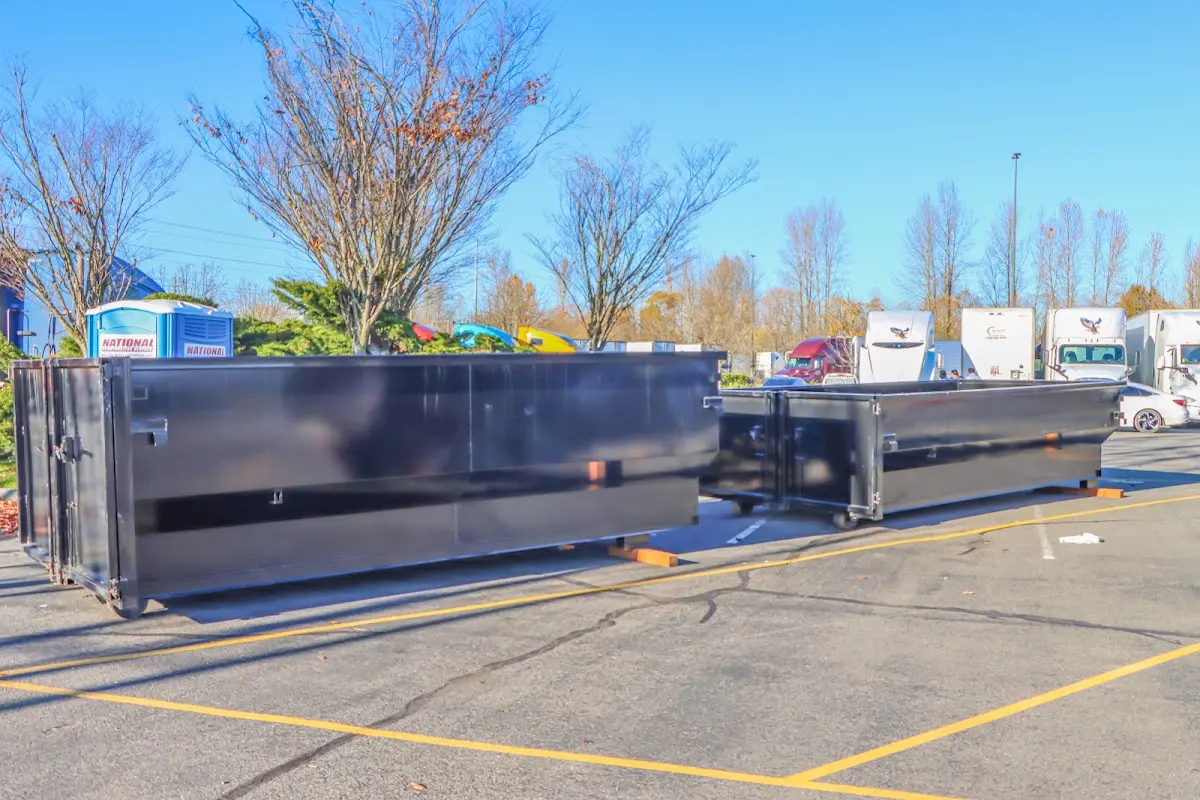 Professional dumpster rental service with roll-off container on residential driveway in Cleveland